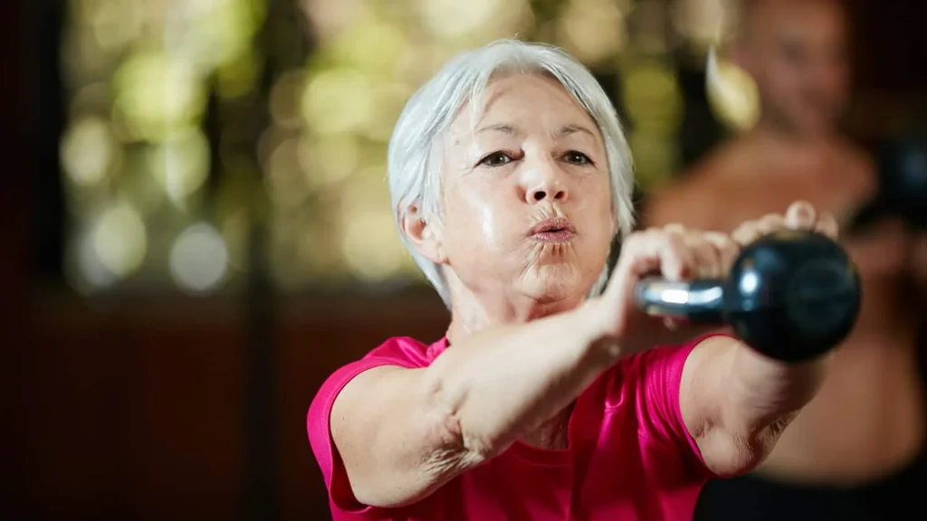 Toning Bingo Wings: Effective Exercises and Tips for Achieving Sleeker Arms 2 Person performing arm exercises with dumbbells Ruislip